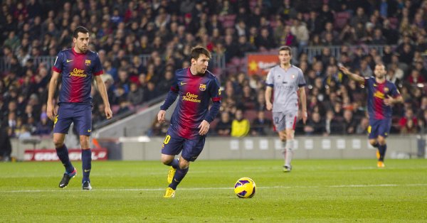 Lionel Messi (center) of FC Barcelona plays against Osasuna; along with Real Madrid, Barcelona is one of Spain's most dominant soccer teams.