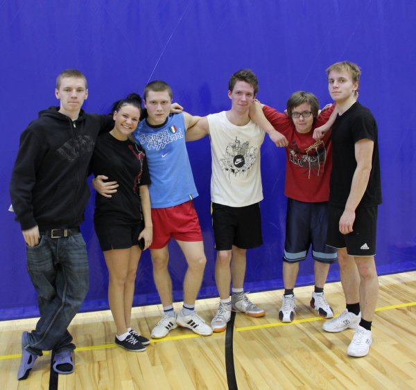 A basketball team pauses to take a group picture; the sport is also well-liked by many Estonian youth.