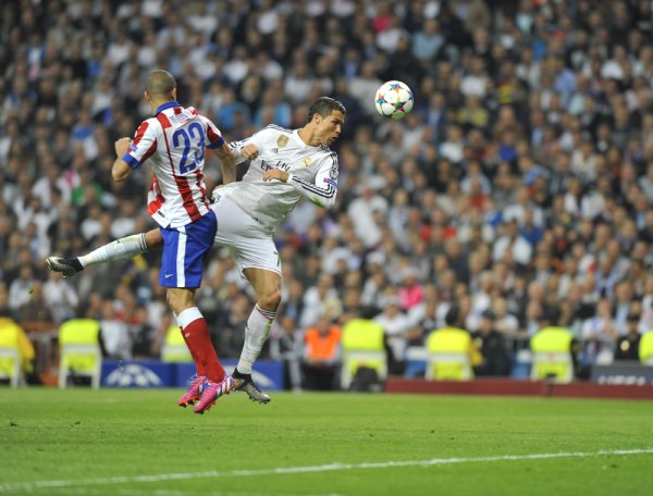 Cristiano Ronaldo of Real Madrid makes a head kick at a match against Atletico de Madrid.