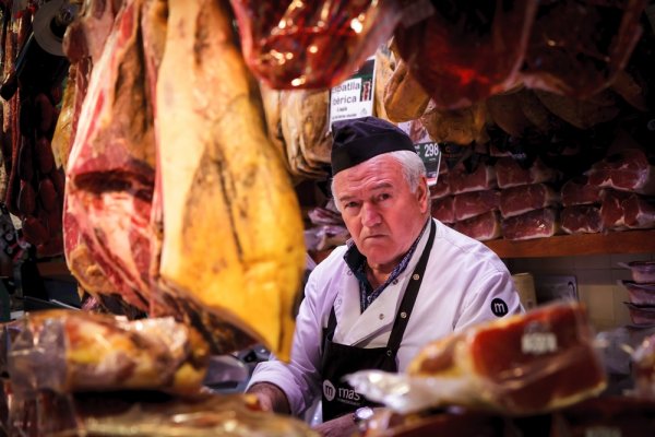 A butcher selling jamón at Mercat de la Boqueria in Barcelona