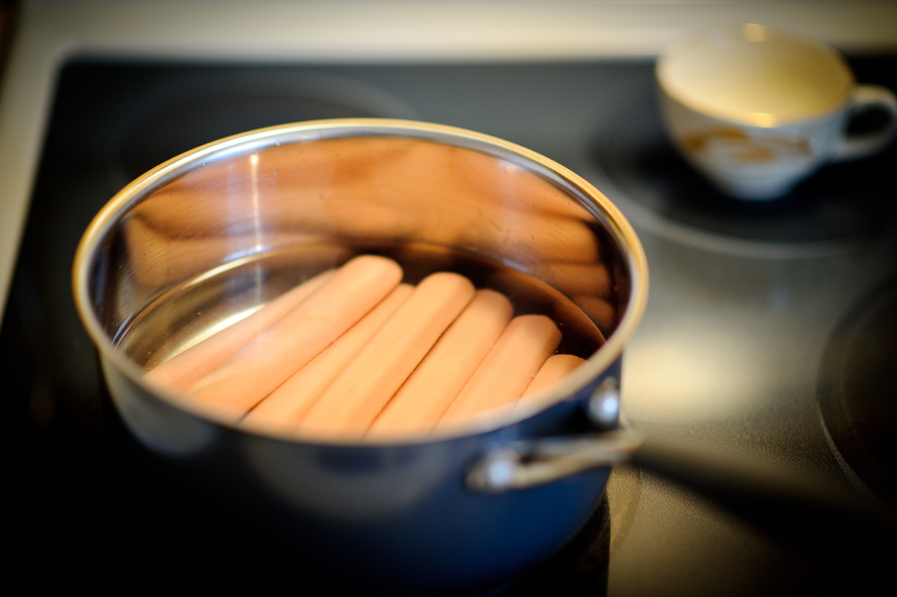 Boil hotdogs in water.