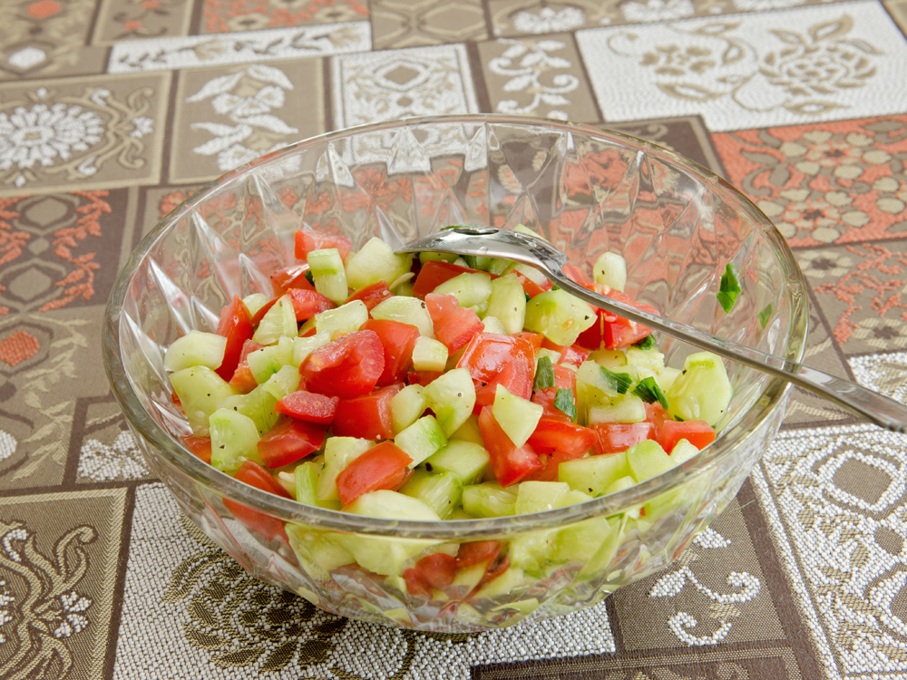 Mixing the cucumbers and tomatoes