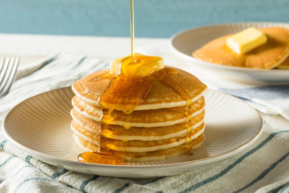 Pancakes topped with butter and syrup.
